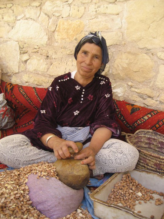 Berber woman crushing Argan seeds, Morocco